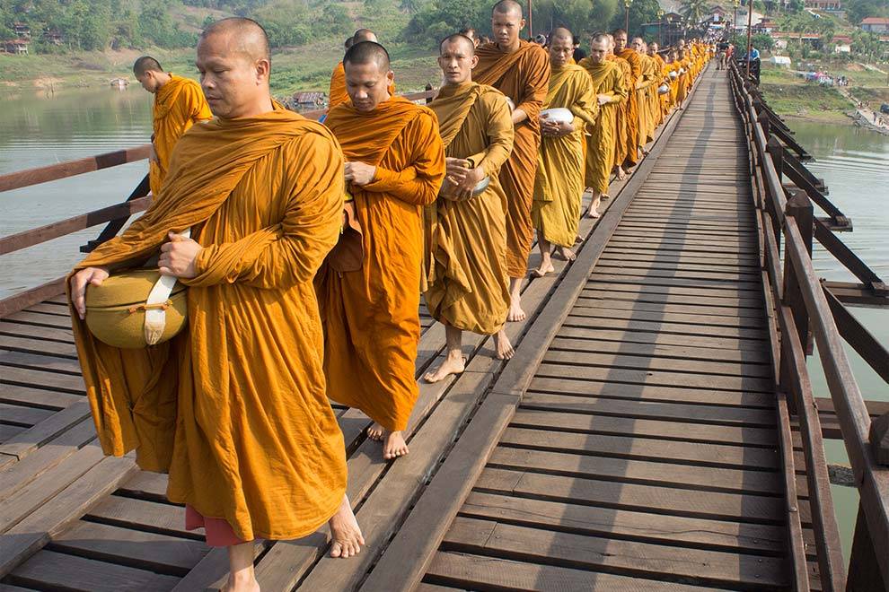 Monjes cruzando el puente de madera